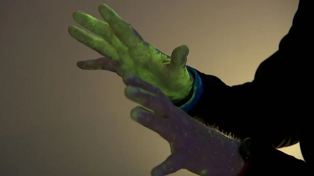SmartWater on hands under UV light